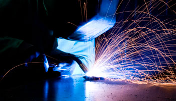 welder welding fire spitting metalworker metal torch